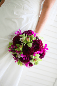 Plum dahlias mix with green and fuchsia orchids for a fresh, modern style. Image provided by Organic Elements Event Design