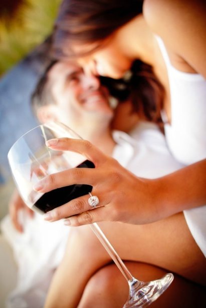 Couple enjoying each other with a glass of wine.