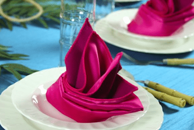 A Bright Napkin Folded Into A Tropical Flower Enhances The Setting. Image Provided By Baker Party Rentals