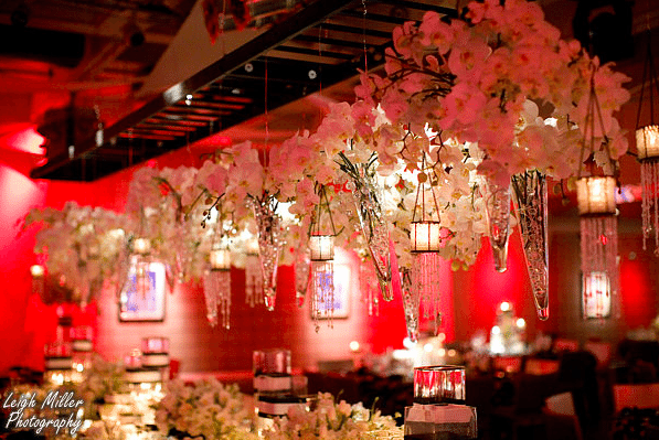 White orchids are suspended in clear vessels filled with crystals for an elegant look Image provided by Kevin Covey Event Design, Photography: Leigh Miller Photography