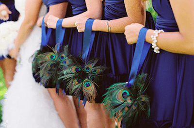 Peacock feathers replace flowers in these keepsake bride's maid bouquets Image provided by Renae's Bouquet