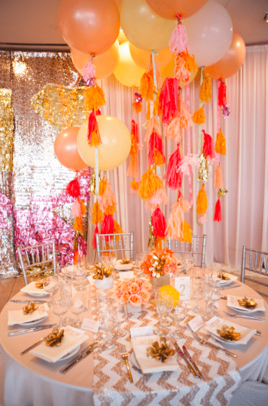Balloons with bright pom-poms elevate this table decor Image provided by White Lilac Event Design